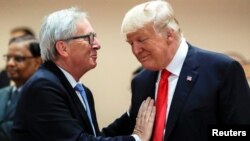 FILE - U.S. President Donald Trump, right, talks with European Commission President Jean-Claude Juncker, left, before a working session at the G-20 summit in Hamburg, Germany, July 8, 2017.