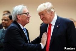 U.S. President Donald Trump, right, talks with European Commission President Jean-Claude Juncker, left, before a working session at the G-20 summit in Hamburg, Germany, July 8, 2017.