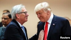 FILE - U.S. President Donald Trump, right, talks with European Commission President Jean-Claude Juncker, left, before a working session at the G-20 summit in Hamburg, Germany, July 8, 2017.