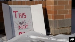 A sign reading "This was not okay," is seen in front of Covington Catholic High School in Park Kills, Ky., Jan 20, 2019. 