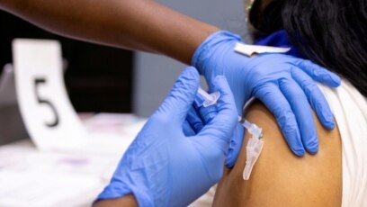 USA, Philadelphia, A woman receives a COVID-19 vaccine 