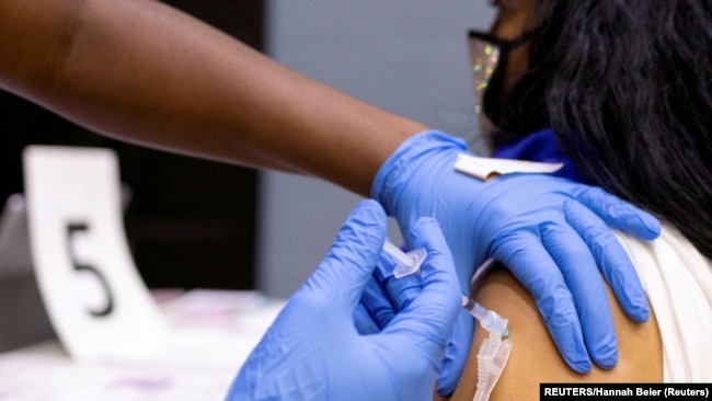 USA, Philadelphia, A woman receives a COVID-19 vaccine 