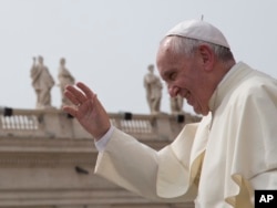 FILE - Pope Francis waves after his weekly general audience in St. Peter's Square at the Vatican, Sept. 9, 2015.