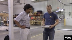 Notre Dame engineering professor Yahya Kurama (left) and graduate student Michael Brandes look over a container of aggregate.