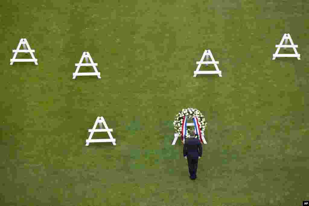 Dutch King Willem-Alexander observes a moment of silence commemorating over 10,000 U.S. Second World War military dead buried at the Netherlands American Cemetery and Memorial in Margraten, southern Netherlands.