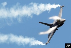 FILE - F16 fighter jet takes part in a flying display during the 49th Paris Air Show.