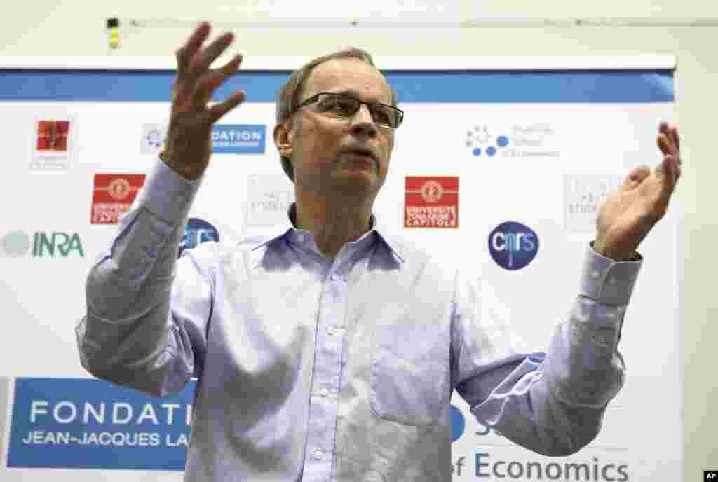 French economist and Nobel Prize laureate Jean Tirole addresses the media during a press conference at the Toulouse School of Economics in Toulouse, southern France, Oct. 13, 2014.