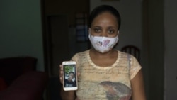 In this Monday, June 15, 2020 photo, Rafaela Matos shows a photo of her son João Pedro Matos Pinto, at her home in Sao Goncalo, Brazil. (AP Photo/Silvia Izquierdo)