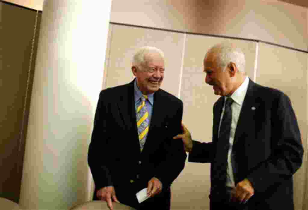 Former President Jimmy Carter, left, and OPEC Fund for International Development Director General Suleiman Jasir Al-Herbish, speak before signing an agreement for two $500,000 grants to fund the Carter Center's programs to eliminate Guinea worm and river