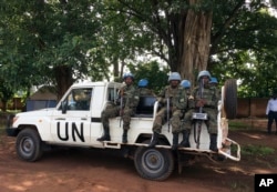 FILE - U.N. peacekeepers drive through Yei, South Sudan, July 13, 2017. The U.N. peacekeeping mission's chief says Yei has "gone through a nightmare." Since fighting spread to the city a year ago, 70 percent of the population has fled.