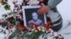 A portrait of Russian military blogger Vladlen Tatarsky, who was killed in the cafe explosion the day before, is placed near the blast site in Saint Petersburg