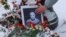 A portrait of Russian military blogger Vladlen Tatarsky, who was killed in the cafe explosion the day before, is placed near the blast site in Saint Petersburg