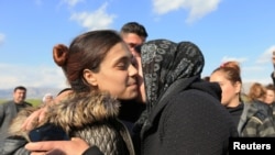 FILE- A relative kisses a Yazidi survivor woman following her release from Islamic State militants in Syria, in Duhok, Iraq, March 2, 2019. 