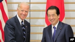 U.S. Vice President Joe Biden, left, is greeted by Japanese Prime Minister Naoto Kan prior to their meeting at Kan's official residence in Tokyo, Aug. 23, 2011