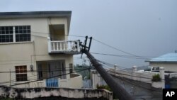 An electrical pole felled by Hurricane Elsa leans on the edge of a residential balcony, in Cedars, St. Vincent, July 2, 2021.