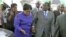 FILE: Zimbabwean President Robert Mugabe (R) is greeted by Vice President Joice Mujuru (L) after a trip to Singapore, April 12, 2012.