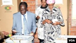 President Robert Mugabe voting in Harare's Highfield suburb Wednesday with his wife, Grace, and daughter Bona.