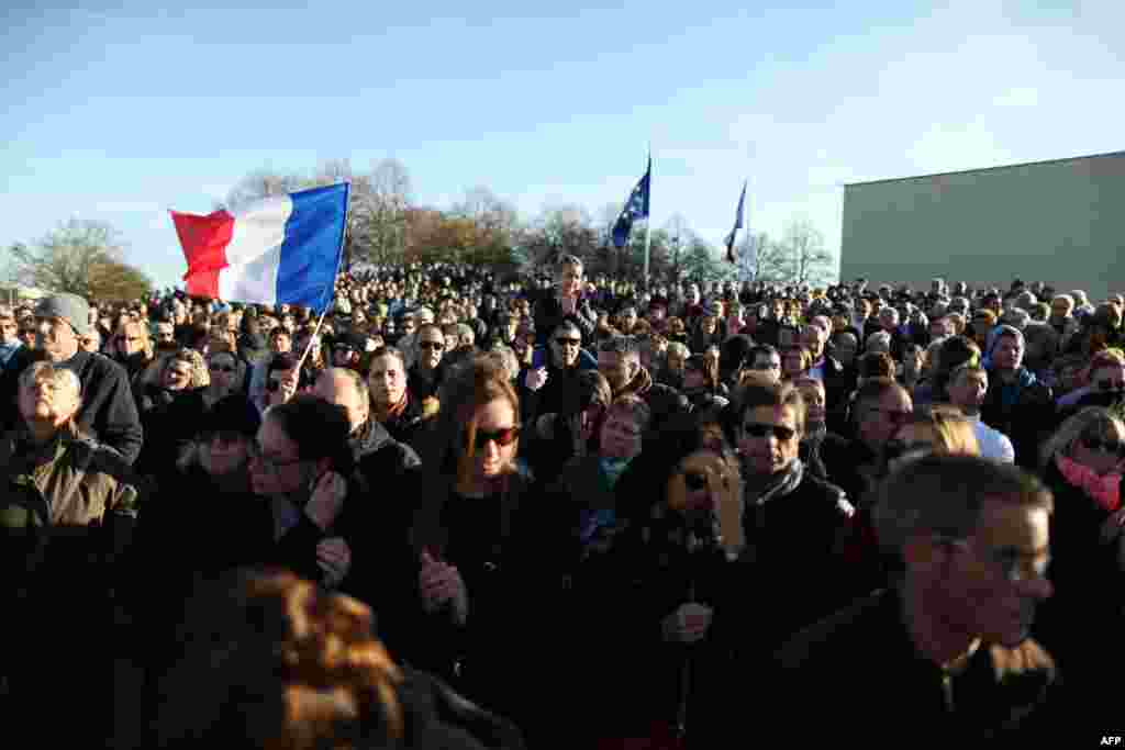 People gather during a demonstration in front of the Memorial of Caen in tribute to the victims of the Paris attacks on Nov. 15, 2015 in Caen. 