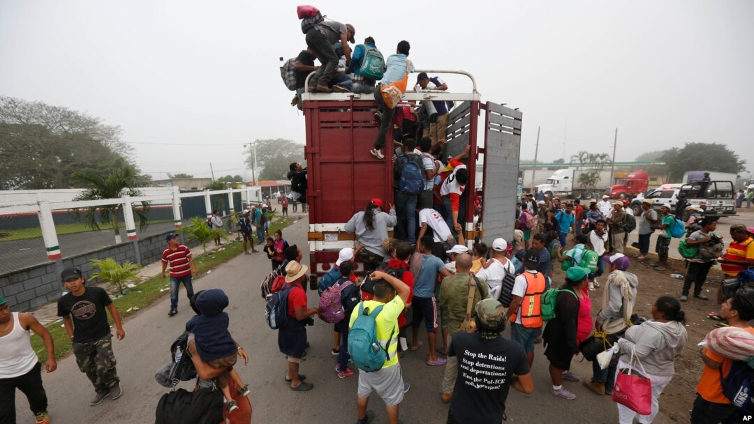 Central American migrants pack into the back of a trailer truck as they begin their morning trek as part of a thousands-strong caravan hoping to reach the U.S. border, in Isla, Veracruz state, Mexico, Sunday, Nov. 4, 2018.