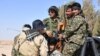 FILE - Afghan fighters with the Fatimiyoun Brigade in Syria.