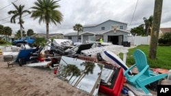 Debris left by Hurricane Helene is piled up in preparation for Hurricane Milton, in New Port Richey, Florida, Oct. 7, 2024.