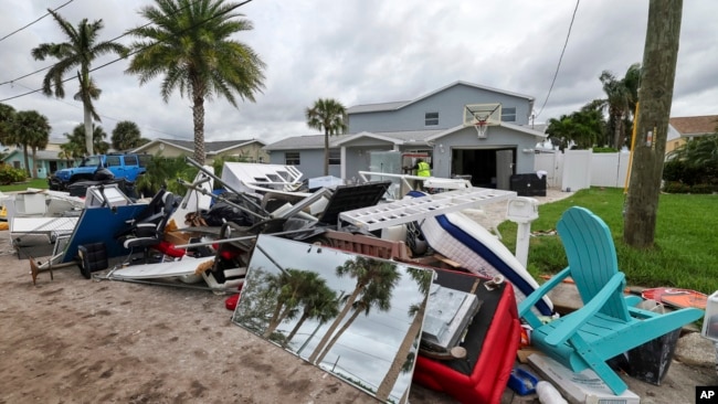 Debris left by Hurricane Helene is piled up in preparation for Hurricane Milton, in New Port Richey, Florida, Oct. 7, 2024.