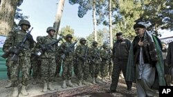 Ashraf Ghani Ahmadzai (R), head of the Transition Commission, inspects an Afghan military guard during a ceremony to hand over security control in Qala Naw, center of Badghis province, File January 31, 2012. 