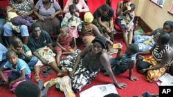 A group of more than 80 Movement for Democratic Change supporters take refuge at party's headquarters in Harare, Zimbabwe, after they were attacked in their homes by suspected ZANU-PF party supporters in Harare, other parts of the country, February, 4, 20