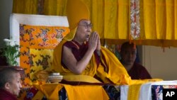 Tibetan spiritual leader the Dalai Lama wears the ceremonial hat of the Gelug school of the Tibetan Buddhism as he prays during his religious talk at the Tsuglakhang temple in Dharmsala, India, March 2, 2018. 