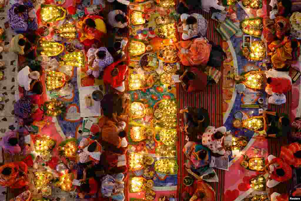 Hindu devotees pray to Lokenath Brahmachari, a Hindu saint and philosopher, as they observe the Rakher Upobash festival, at a temple in Dhaka, Bangladesh.