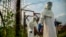Medical staff are sterilized before entering the isolation unit at a hospital in Bundibugyo, western Uganda, on Aug. 17, 2018, where there is one suspected case of Ebola.