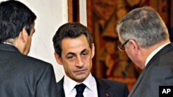 France's President Nicolas Sarkozy speaks with ministers at the end of the weekly cabinet meeting at the Elysee Palace in Paris, February 23, 2011