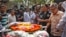 Father Ajay Roy, right, stands beside the coffin of Avijit Roy, a prominent Bangladeshi-American blogger in Dhaka, Bangladesh, March 1, 2015.