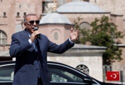 FILE - Turkish President Recep Tayyip Erdogan talks to the media in Istanbul, Turkey, Aug 7, 2020.