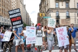 FILE - People gather to protest recent mandates requiring vaccines against the coronavirus, in New York's Central Park, Aug. 21, 2021.