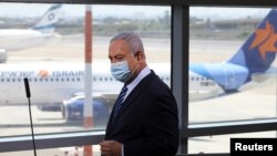 Israeli Prime Minister Benjamin Netanyahu prepares to give a statement at Ben Gurion International Airport, in Lod, near Tel Aviv, about preparations for direct flights, over Saudi Arabia, to the United Arab Emirates, August 17, 2020.