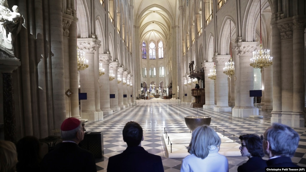 French President Emmanuel Macron, center left, and his wife Brigitte Macron, third right, visit the restored interiors of Notre-Dame Cathedral, Friday, Nov.29, 2024 in Paris. (Christophe Petit Tesson, Pool via AP)