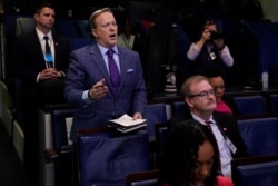 Former White House press secretary Sean Spicer and reporter for Newsmax, left, attends a coronavirus task force briefing at the White House, March 20, 2020.