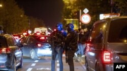 TOPSHOT - Police officers stand guard as supporters leave the King Baudouin Stadium following the Euro 2024 qualifying football match between Belgium and Sweden in Brussels on October 16, 2023, after two Swedes were shot dead in an attack in Brussels.