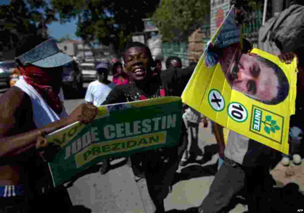 People tear up photos of presidential candidates to protest upcoming elections and the UN's presence regarding the cholera epidemic in Port-au-Prince, Haiti, Wednesday Nov. 17, 2010. Haiti will hold elections on Nov. 28 in the midst of a month-old choler