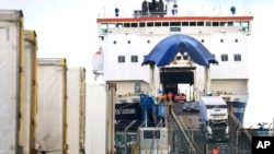 File - Lorries and cars disembark from a ferry arriving from Scotland at the port on the north coast of Northern Ireland, Jan. 1, 2021, the day after Britain's Brexit split with the European bloc's vast single market for people, goods and services.