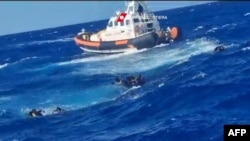 This photograph taken on August 5, 2023 by Italian Coastguard and released on August 6, 2023, shows a rescue operation that took place south of Lampedusa, consisting in rescuing 57 migrants, also recovering the lifeless bodies of a woman and a minor on board. 