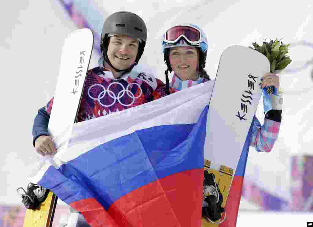 Russia&#39;s Vic Wild (left) poses after winning the gold medal in the men&#39;s snowboard parallel giant slalom final, with his wife and bronze medalist in the women&#39;s snowboard parallel giant slalom final, Russia&#39;s Alena Zavarzina, Krasnaya Polyana, Russia, Feb. 19, 2014. 