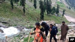 FILE - Hindu pilgrims walk uphill as they participate in the annual Yatra Amarnath near Chandanwa, Indian-controlled Kashmir, July 27, 2019. This year's pilgrimage has been canceled because of the coronavirus.