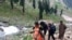 FILE - Hindu pilgrims walk uphill as they participate in the annual Yatra Amarnath near Chandanwa, Indian-controlled Kashmir, July 27, 2019. This year's pilgrimage has been canceled because of the coronavirus.