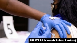 USA, Philadelphia, A woman receives a COVID-19 vaccine 