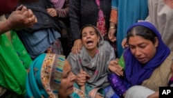 Family members and relatives cry after a boat carrying people including children capsized in Jhelum river on the outskirts of Srinagar, Indian-controlled Kashmir, Tuesday, April. 16, 2024. 