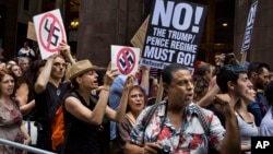 Protesters shout slogans in front of Trump Tower ahead President Donald Trump's visit to the building New York, Aug. 14, 2017.