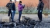 Russian law enforcement officers inspect the wreckage of a drone following a drone attack in the village of Sofyino, Moscow region, Nov. 10, 2024. 