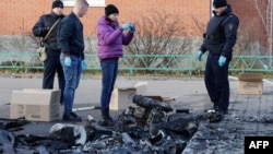 Russian law enforcement officers inspect the wreckage of a drone following a drone attack in the village of Sofyino, Moscow region, Nov. 10, 2024. 